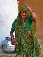 Rajasthani woman standing beside water pitcher